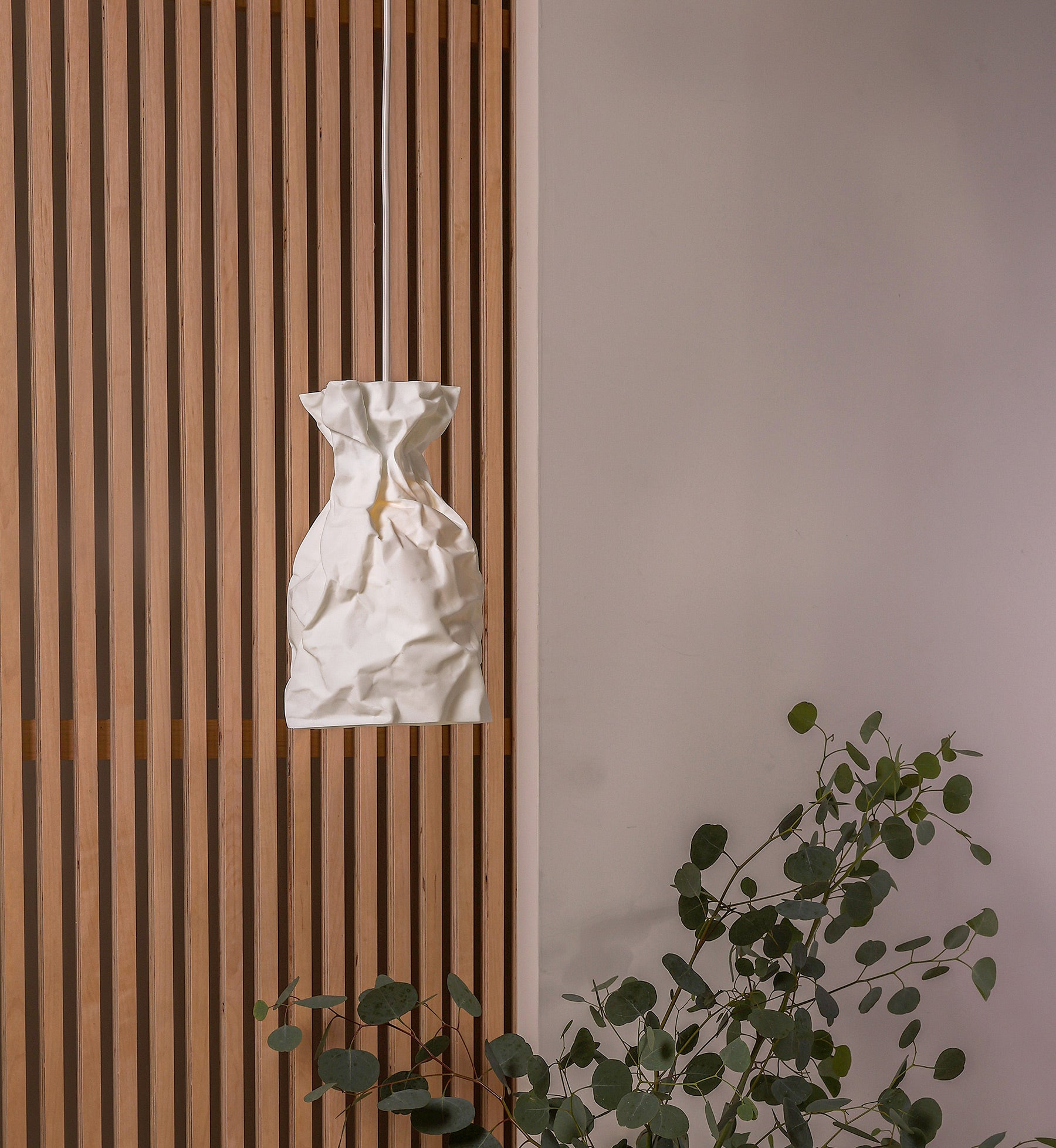 A Pendant Lamp of wrinkle & crinkle paper that echoes of shadow & balance