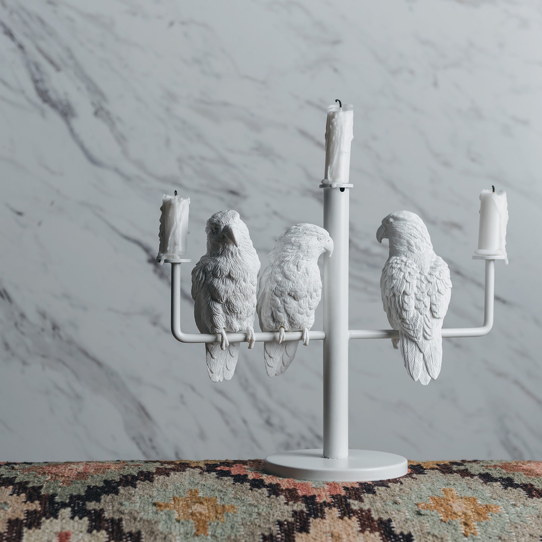Three parrots create ambiance and good mood as candleholders