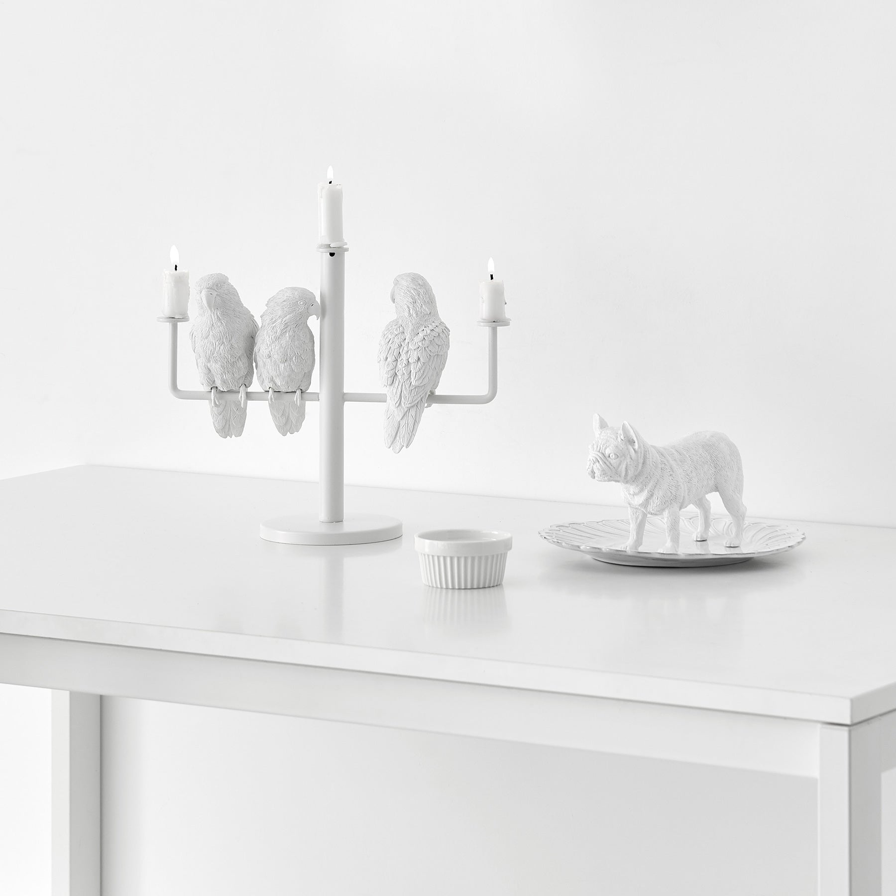 Three parrots create ambiance and good mood as candleholders