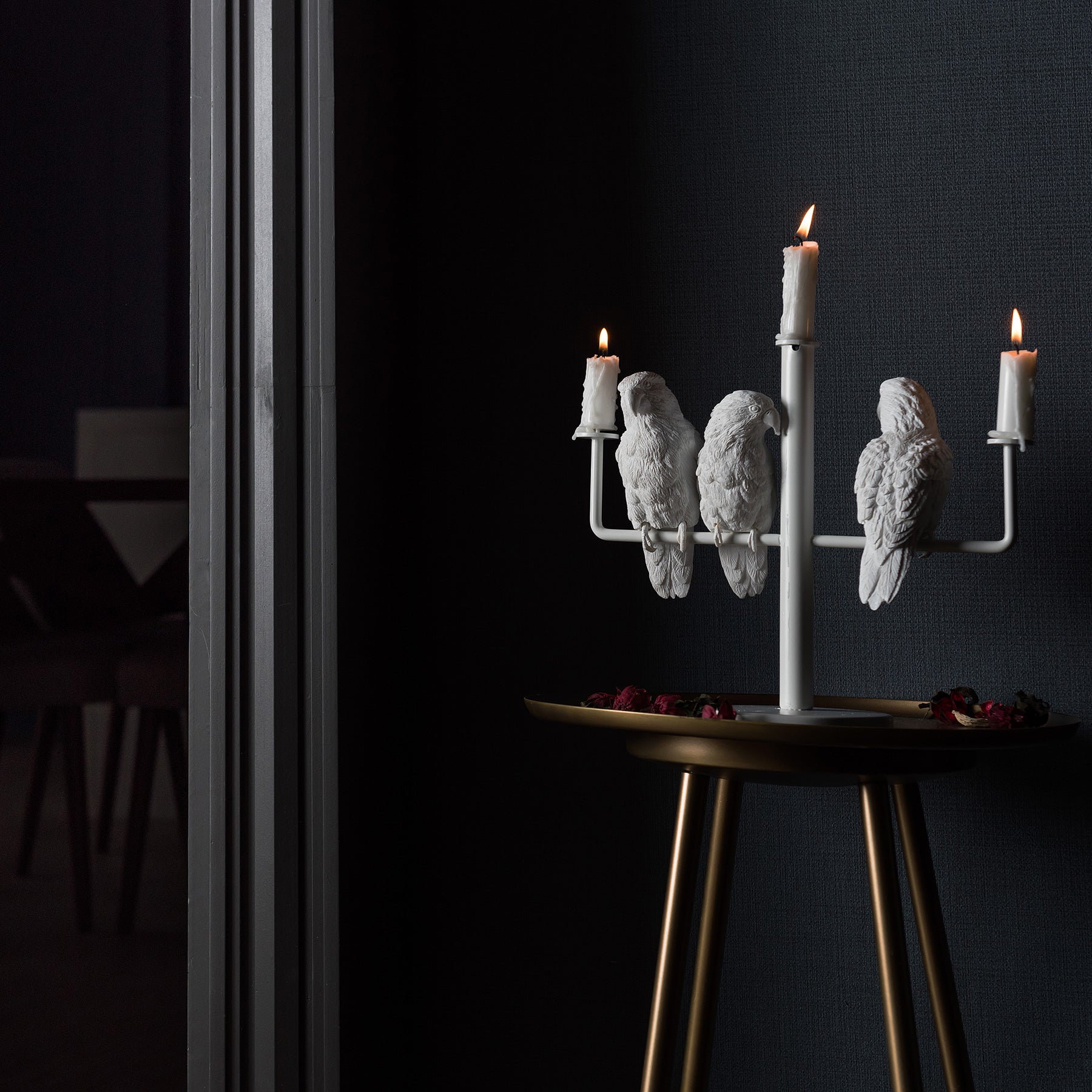 Three parrots create ambiance and good mood as candleholders