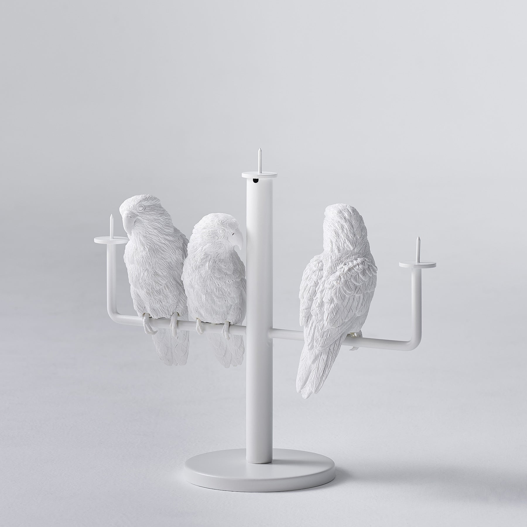 Three parrots create ambiance and good mood as candleholders